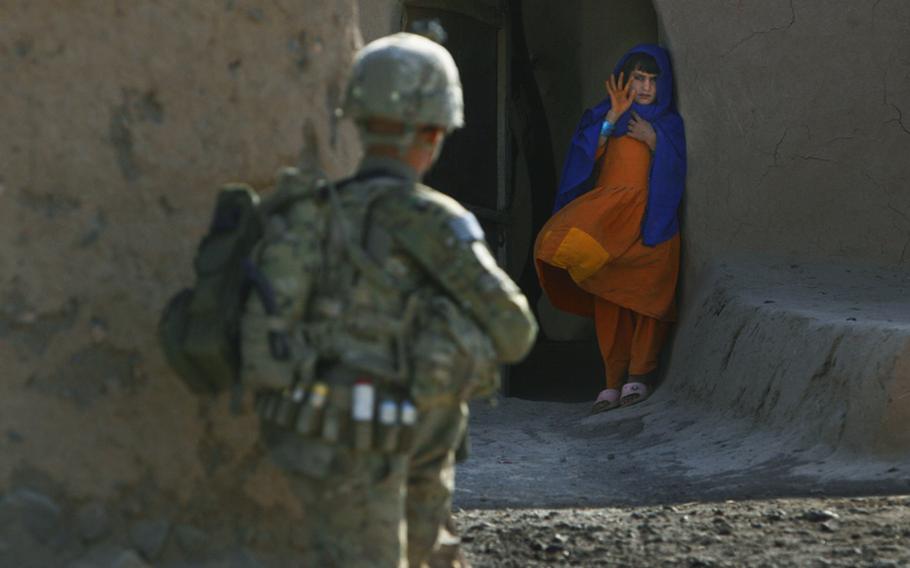 An Afghan girl waves to Pfc. Mackenzie Wilson of Company F, 4th Battalion, 101st Aviation Regiment, 159th Combat Aviation Brigade, 101st Airborne Division, who was patrolling her village of Loy Shur on Sept. 23, 2011, in Zabul province, Afghanistan.