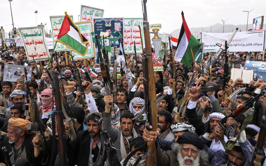 Middle Eastern men yell during a rally in Yemen.