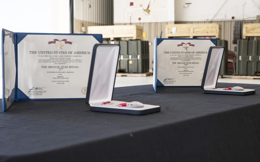 Two Bronze Stars with valor sit on a table at Davis-Monthan Air Force Base, Ariz.,  Oct. 1, 2020. Air Force Master Sgt. Adam Fagan and Staff Sgt. Benjamin Brudnicki, both 48th Rescue Squadron pararescuemen, were awarded Bronze Stars with valor for their actions during separate missions last year in Afghanistan.

