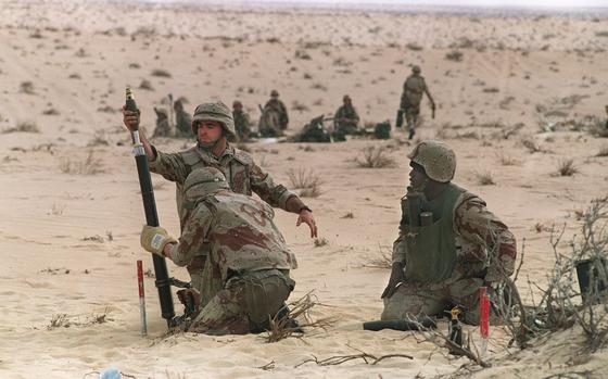 U.S. Marines from the 3rd Battilion, 6th Marines, fire a 60mm mortar during a live fire exercise on Jan. 11, 1991, in the desert of Saudi Arabia as part of the "Operation Desert Shield." 