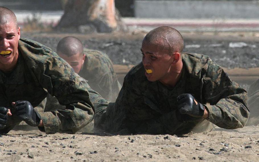 Marine recruits crawl through dust during pre-combat training Aug. 13, 2010, at Marine Corps Recruit Depot San Diego. Defense Secretary Robert Gates inspected the recruits and presided over the graduation of the previous class.
