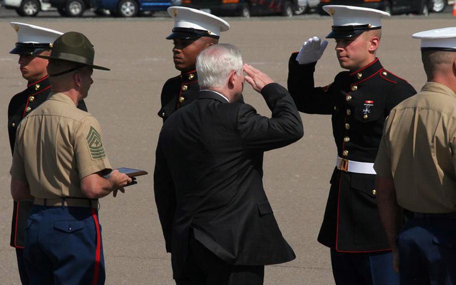 Defense Secretary Robert Gates salutes Marines