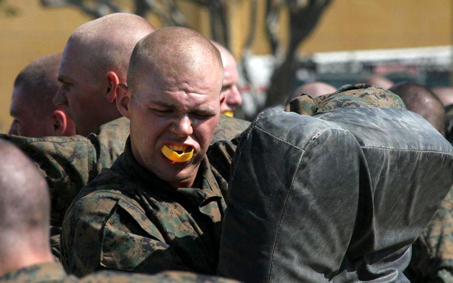 Marine recruits crawl through dust during pre-combat training Aug. 13, 2010, at Marine Corps Recruit Depot San Diego. Defense Secretary Robert Gates inspected the recruits and presided over the graduation of the previous class.