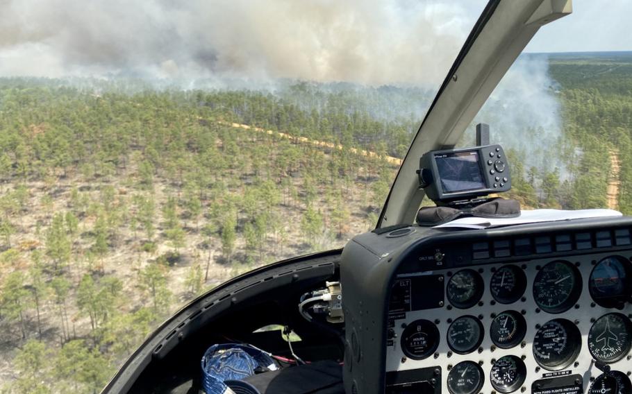 A smoke plume is seen from above following a controlled burn, April 23 on Fort Stewart, Georgia. The contracted helicopter is used to drop small balls of incendiary substances to burn hardwood plants in the Fort Stewart-Hunter Army Airfield training area, April 23 on Fort Stewart. 