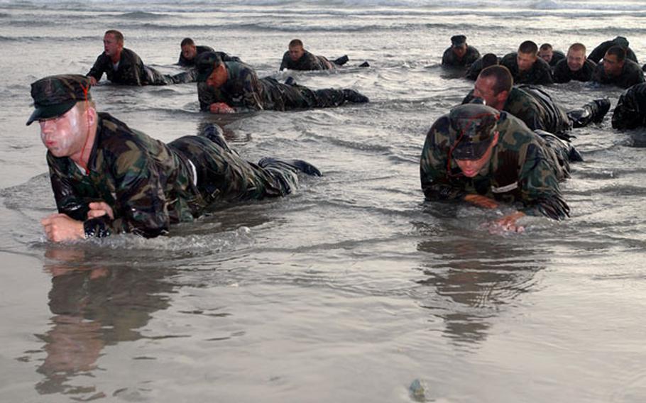 Real Navy SEALs endure bitter cold during a training exercise. Participants in the Extreme SEAL Experience pay $1,900 to undergo scaled-down versions of the grueling training. 