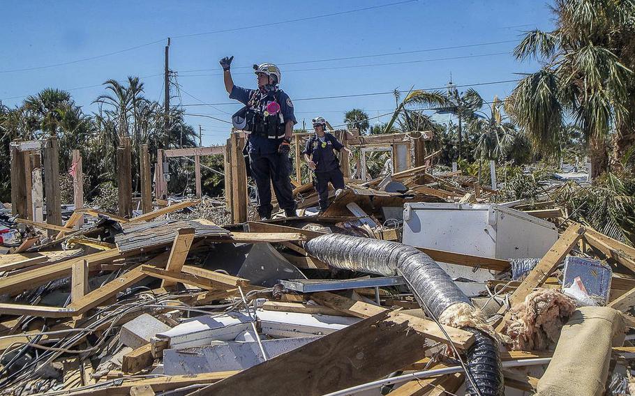 A member of a search and rescue team confirms the discovery, after searching the rubble on a property in Fort Myers Beach on Friday Sept. 30, 2022, two days after Hurricane Ian hit Florida’s west coast as a Category 4 storm.