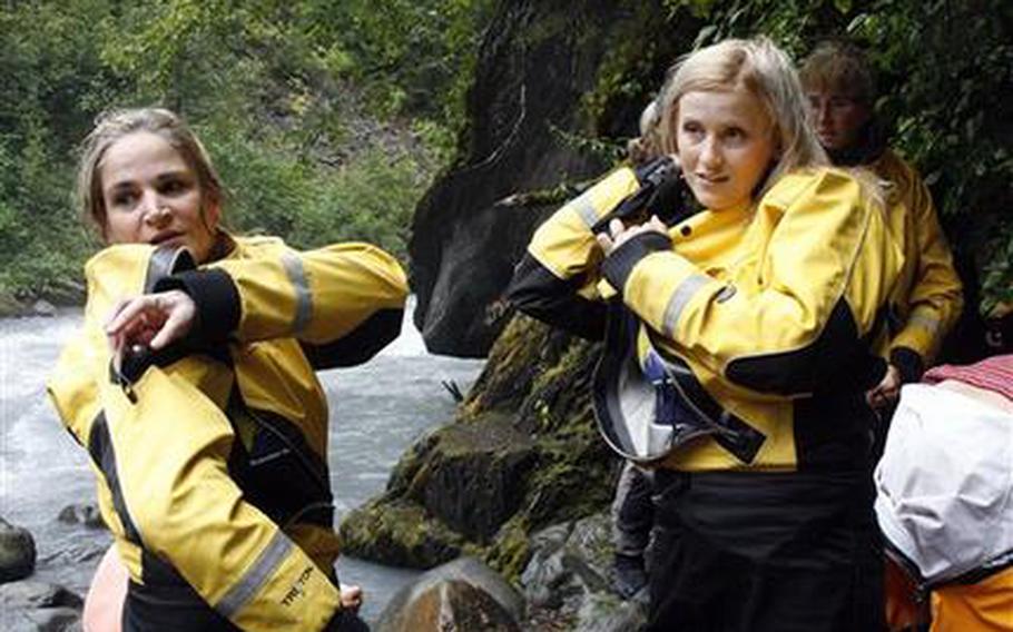 Julie Robinson of Ligonier, Pa., left, and Jennifer Hankins of San Diego, put on wet suits before a white water rafting trip on Crow Creek, near Girdwood, Alaska in early August 2011. 