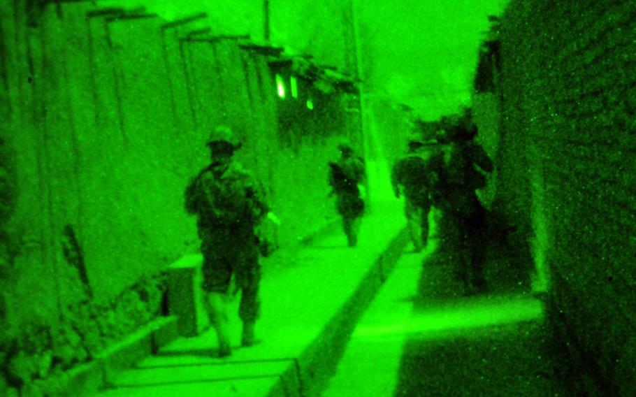 U.S. servicemembers assigned to the Zabul Provincial Reconstruction Team (PRT) provide security during a night mission in Qalat City, Afghanistan, March 16, 2011. The PRT checked to make sure that supplies ordered by Afghan government agencies were delivered. 