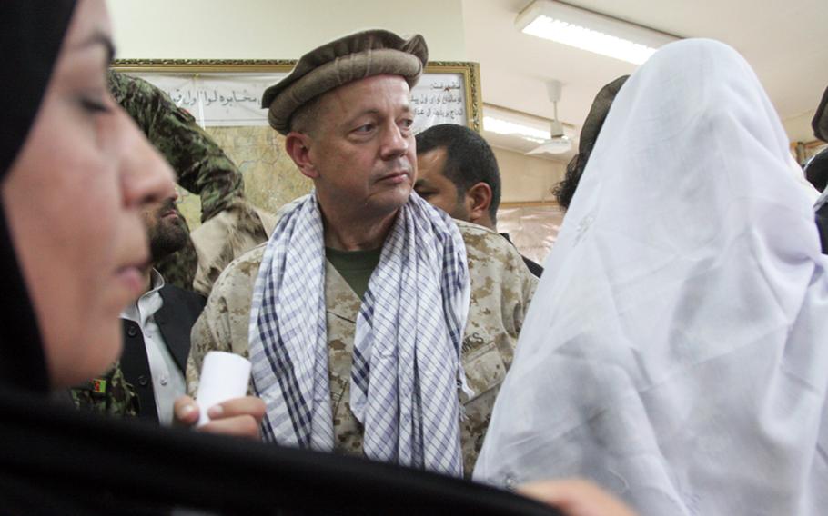 Gen. John R. Allen, pictured May 15, 2010, when he was deputy commander of U.S. Center Command, wears an Afghan hat and scarf as he leaves a special release ceremony for 11 Afghan detainees in Kabul, Afghanistan. 