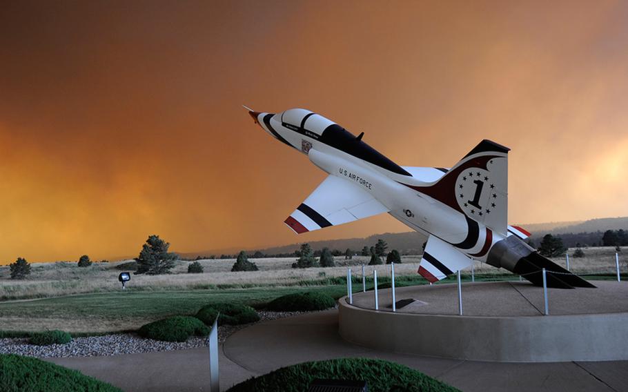 A rapidly spreading smoke cloud surrounds the U.S. Air Force Academy's airfield in Colorado Springs, Colo., June 26, 2012. 