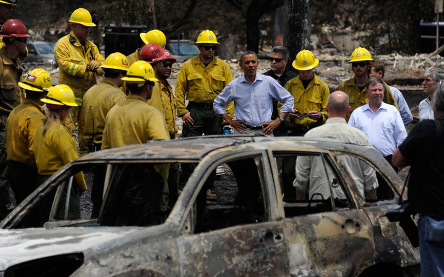 President Barack Obama talks with firefighters in Mountain Shadow as he toured decimation from The Waldo Canyon Fire in Colorado, Friday, June 29, 2012. 