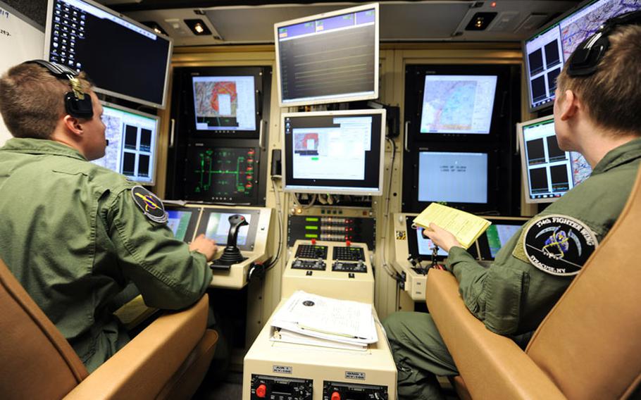 A student pilot and sensor operator man the controls of a MQ-9 Reaper in a ground-based cockpit during a training mission flown from Hancock Field Air National Guard Base, Syracuse, New York. 