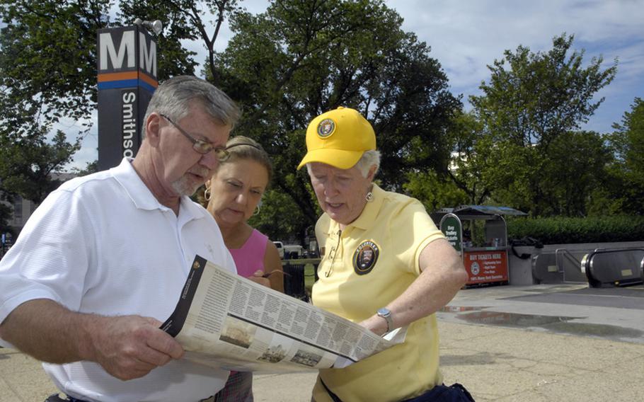 Lynne Kennedy, a volunteer roving docent, assists tourists in need of direction and information on the National Mall in Washington, D.C. 