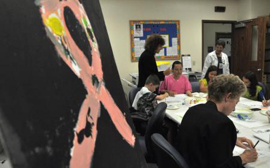 Cancer patients and oncology staffers participate in an artistic therapy program at Tripler Army Medical Center on Oct. 14, 2009. 