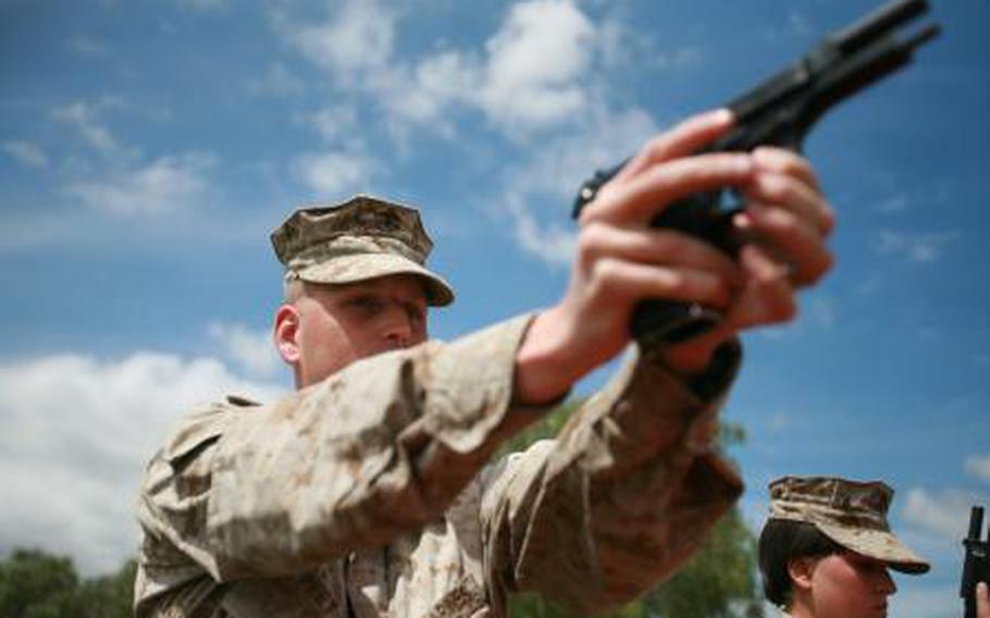 A Marine practices a speed reload at the pistol range in Omega, Ga., April 28, 2009.