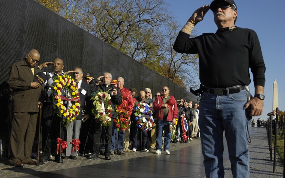 Visitors to the Vietnam Veterans Memorial on Nov. 11, 2012 pay tribute to those who died in the war.