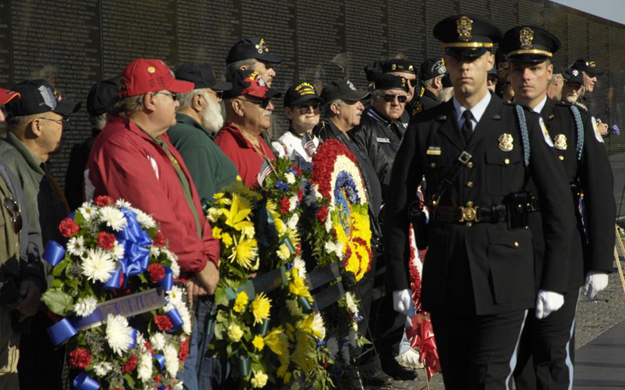 Visitors to the Vietnam Veterans Memorial on Nov. 11, 2012 pay tribute to those who died in the war.