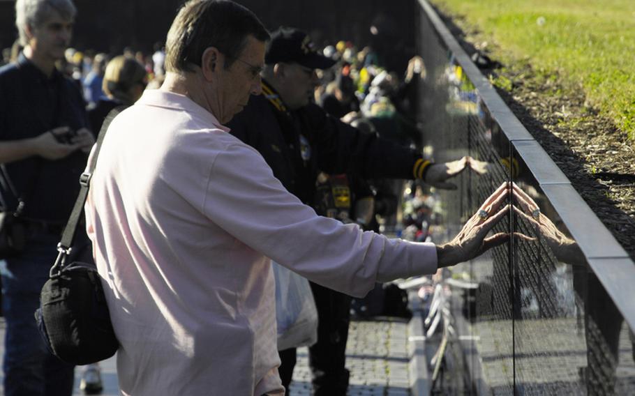 Visitors to the Vietnam Veterans Memorial on Nov. 11, 2012 pay tribute to those who died in the war.