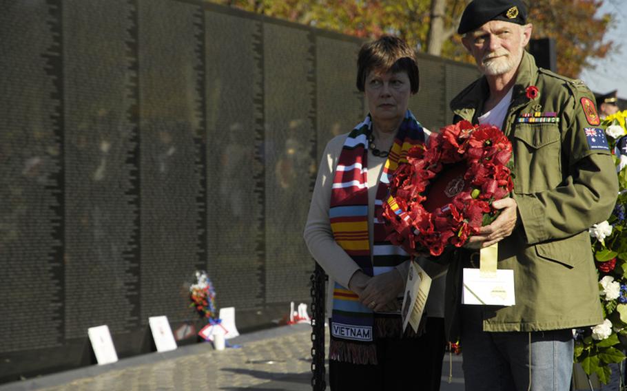 Visitors to the Vietnam Veterans Memorial on Nov. 11, 2012 pay tribute to those killed in the war during a wreath-laying ceremony.