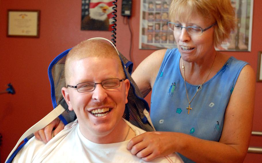 Christine Schei with her son, Erik, during one of his therapy sessions. Army Spc. Erik Schei was shot in the head during a patrol in Iraq on Oct. 26, 2005. The doctors said he would never recover from the catastrophic brain injury, and urged the family to take him off life support.