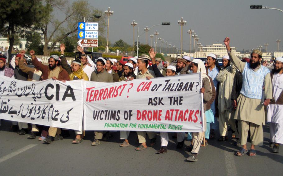 Demonstrators against CIA-operated American drone strikes in Pakistan march along the main thoroughfare in Islamabad, Jinnah Avenue, December 10, 2010. The presidential palace can be seen in the background. 