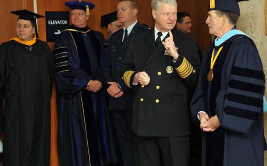 Dan Oliver (far right), president of the Naval Postgraduate School, talks with former Chief of Naval Operations Adm. Gary Roughead at a 2011 graduation. Oliver, a retired vice admiral, and an associate have been relieved of duty after an investigation found evidence of mismanagement.