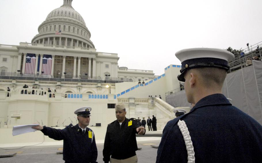 Servicemembers involved in logistics for the upcoming inauguration discuss procedures prior to the rehearsal for the event at the U.S. Capitol on January 13, 2013.