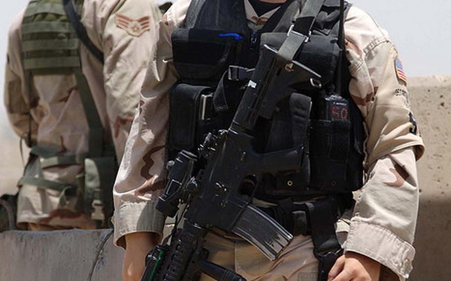 Airmen with the 447th Expeditionary Security Forces Squadron watch the main gate at Sather Air Base, Iraq, July 16, 2007.