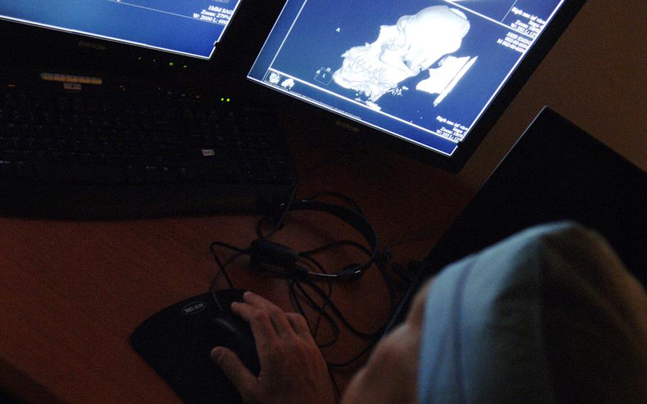 Lt. Col. (Dr.) Wilmer Jones, 332nd Expeditionary Medical Group vascular surgeon, reviews medical images at Joint Base Balad, Iaq on April 13, 2009.