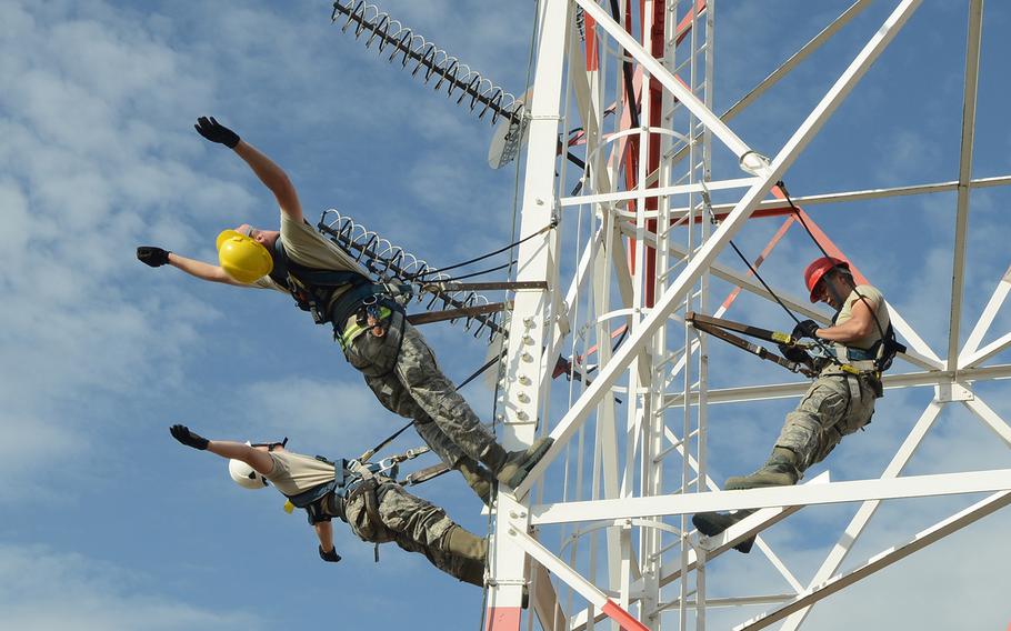 Senior Airmen Skyler Shull and Tony Terry and Airman 1st Class Austin Johnson with the 31st Communications Squadron perform antenna maintenance training June 12, 2013, at Aviano Air Base, Italy. The training included different maintenance techniques, which help them to trust their rappelling equipment.