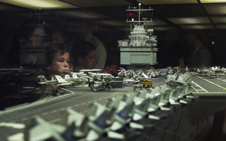 Children get a close-up look at a model of the USS Enterprise at the Smithsonian National Air and Space Museum on July 2, 2013. The model, built by Stephen Henninger, took 1,000 hours a year for 12 years to build and was completed in August 1982. The model is constructed based on the 1975 configuration of the USS Enterprise, which was the world's first nuclear-powered aircraft carrier and was recently inactivated.