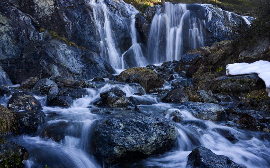 A mountain stream cascades above the Chamonix Valley, France.

