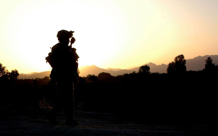 A soldier on patrol as the sun rises in the Sangin Valley of southern Afghanistan in this May 2004 photo. The Sangin Valley is one of the heaviest poppy-producing regions in the world and has a reputation as a drug lord, Taliban and al-Qaida stronghold, making it one of the most dangerous places for U.S. and coalition forces in Afghanistan. 