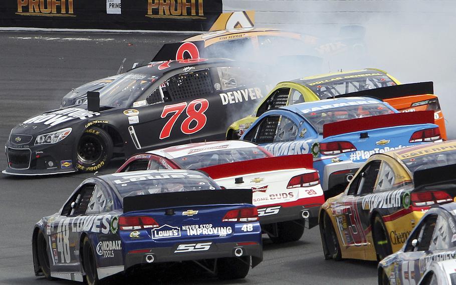 Kurt Busch and Ryan Newman, rear, get sideways in Turn 2 during the NASCAR Sprint Cup series auto race at New Hampshire Motor Speedway, Sunday, July 14, 2013, in Loudon, N.H.  (AP Photo/Jim Cole)