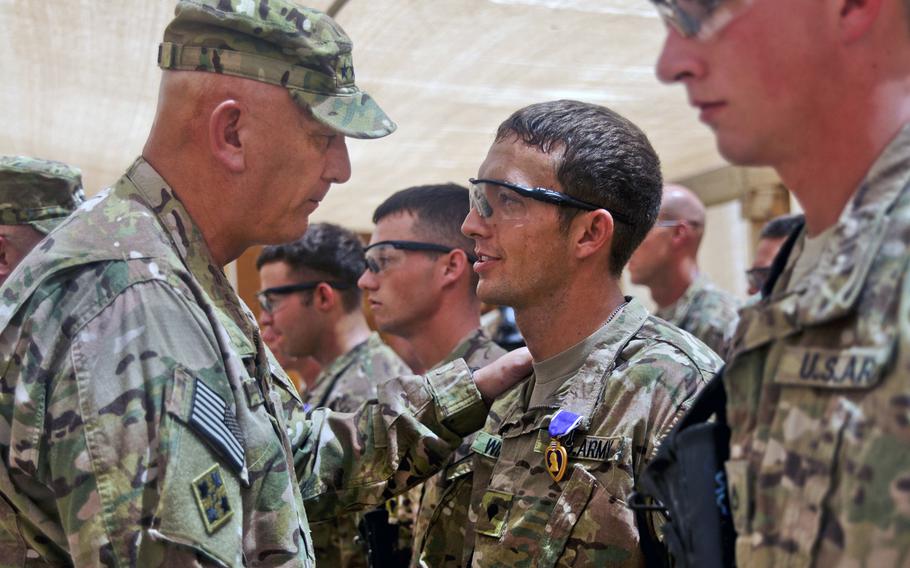 U.S. Army Chief of Staff Gen. Ray Odierno presents the Purple Heart to U.S. Army Spc. Thomas Wirthlin during a ceremony on Forward Operating Base Azzizullah, Afghanistan, on Aug. 7, 2013.
