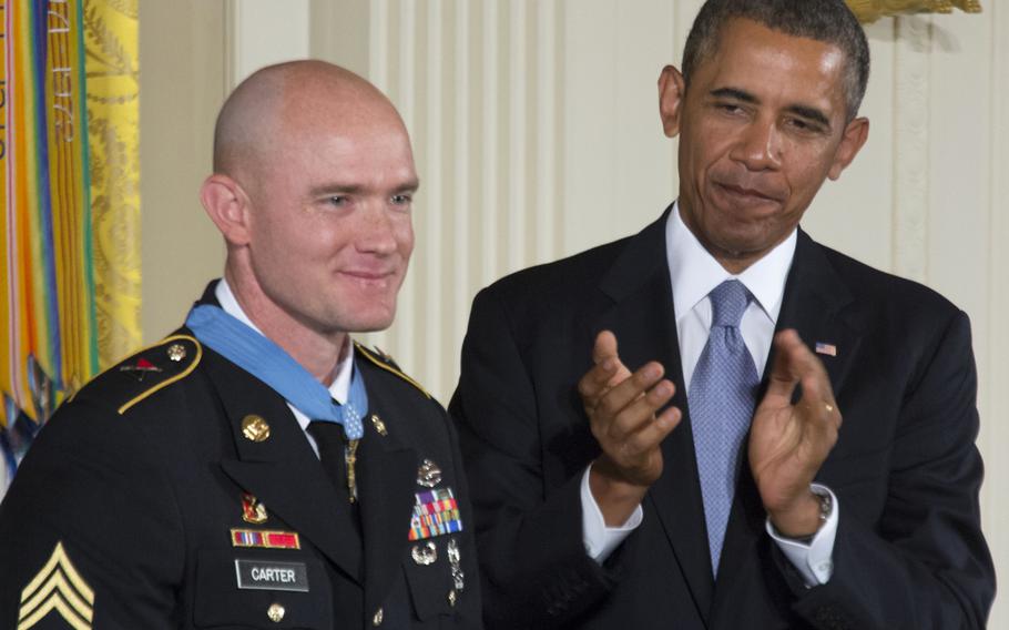 President Barack Obama leads the applause for Army Staff Sgt. Ty Carter after presenting him with the Medal of Honor Monday, August 26, 2013 at the White House.