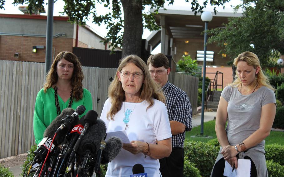 Joleen Cahill, widow of Michael Cahill, reads a statement to the media Aug. 28, 2013, as her children, Keely Vanacker, left, James Cahill and Kerry Cahill stand behind her. Michael Cahill was shot and killed by Maj. Nidal Hasan during the 2009 mass shooting at the clinic on post where Cahill worked. Hasan was sentenced to death Aug. 28, 2013.