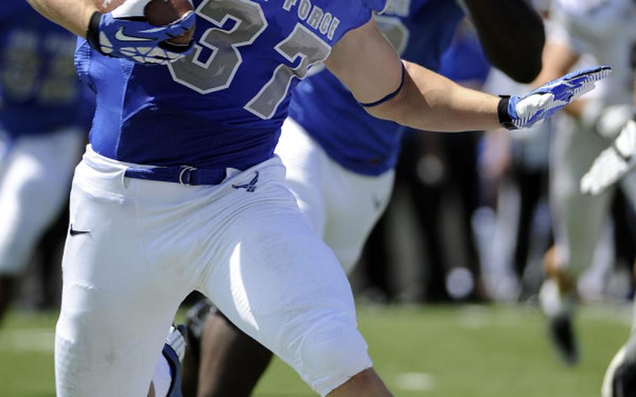 Air Force senior running back Anthony LaCoste searches for room during his team’s 38-13 home win over Colgate on Aug. 31, 2013. 