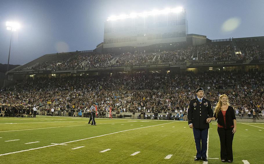 Army Staff Sgt. Ty Carter and his wife, Shannon, are honored during the home football game at West Point on Aug. 30, 2013. Four days earlier, Carter became one of only eight men to receive the Medal of Honor for exemplary heroism in the Afghanistan War.