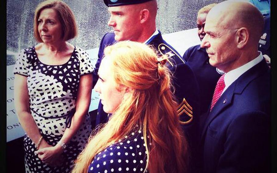 Army Staff Sgt. Ty Carter and his wife, Shannon, both middle, are escorted on a tour of the 9/11 Memorial with museum director Alice Greenwald, left, and FDNY Commissioner Sal Cassano, right, Aug. 29, 2013.