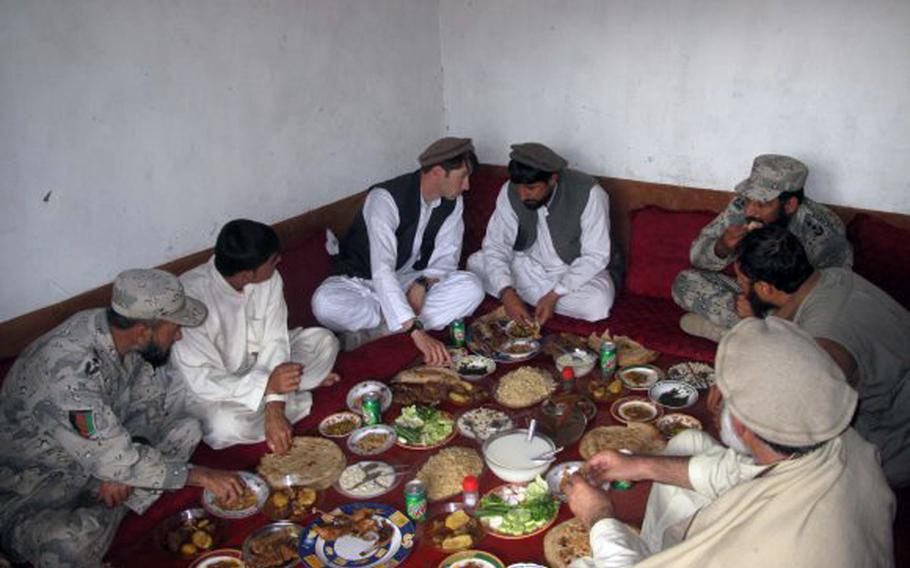 Capt. William Swenson has lunch with Afghan National Army local leadership and former Mujahadeen outside of Asadabad, Afghanistan, in March 2009.