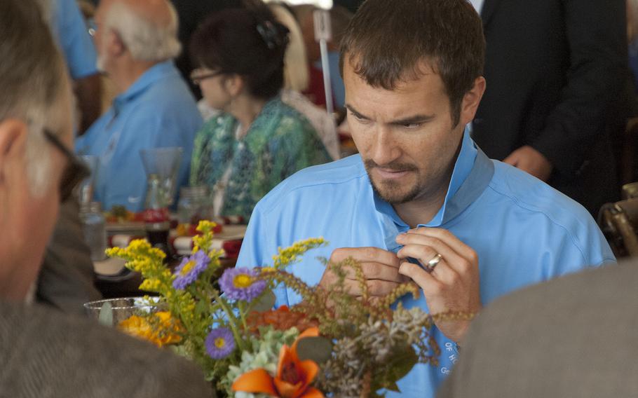 Medal of Honor recipient Salvatore Giunta adjusts his medal at the start of lunch during one day of the multi-day annual convention of the Medal of Honor Society. 
