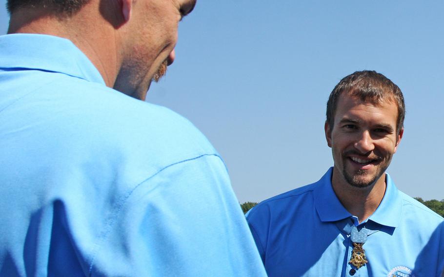 Clinton Romesha, left, takes a moment to chat with fellow Medal of Honor recipient Salvatore Giunta on Sept. 19, 2013.
