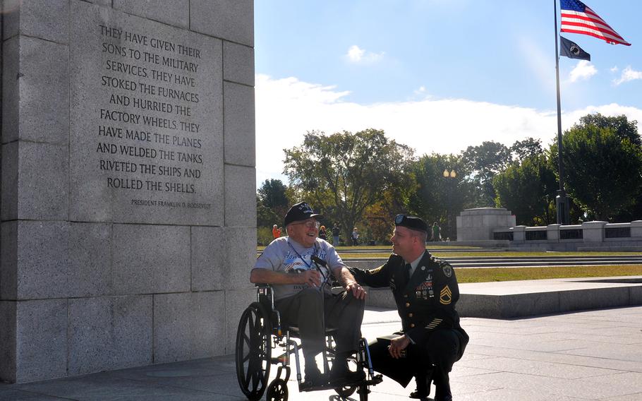 World War II veteran Ron Graham talks with his Honor Flight guardian Sgt. 1st Class Howard Havens.