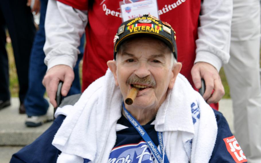 Michael Caracco smiles for the camera during his New England Honor Flight on Sept. 28, 2013. Behind him is his Honor Flight guardian, his son. 