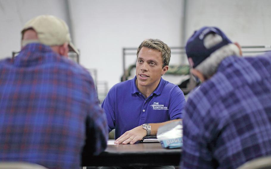 Navy veteran Tristan Williamson speaks to homeless veterans during a service project in San Diego earlier this year. Williamson, a former Mission Continues fellow, is heading up one of the group's new service platoons.