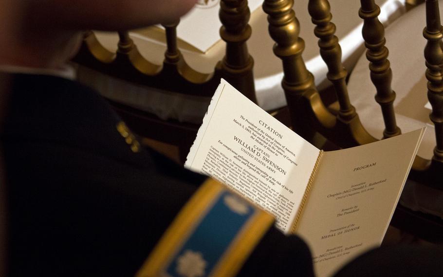 Someone waits for the Medal of Honor ceremony of William Swenson to start on Tuesday, October 15, 2013.