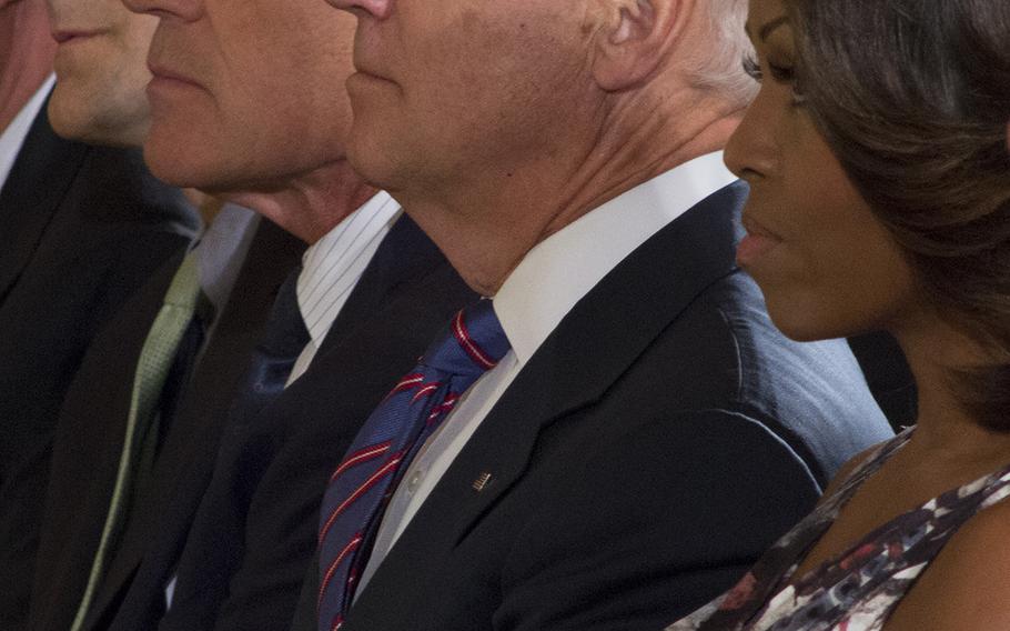 From left to right: White House Chief of Staff Denis McDonough, Defense Secretary Chuck Hagel, Vice President Joe Biden, and First Lady Michelle Obama attend the Medal of Honor ceremony for Capt. William Swenson. 