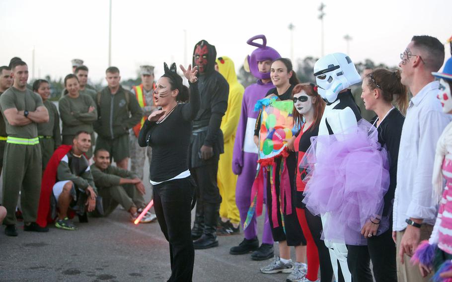 Gunnery Sgt. Joanna H. Mendoza, Headquarters Company gunnery sergeant, Combat Logistics Regiment 17, 1st Marine Logistics Group, holds a costume competition at the end of a Halloween-themed physical training circuit aboard Camp Pendleton, Calif., Oct. 30, 2013. The event's festivities built camaraderie and provided the Marines with an opportunity to unwind and have fun with their peers. (U.S. Marine Corps photo by Lance Cpl. Shaltiel Dominguez/ Released)