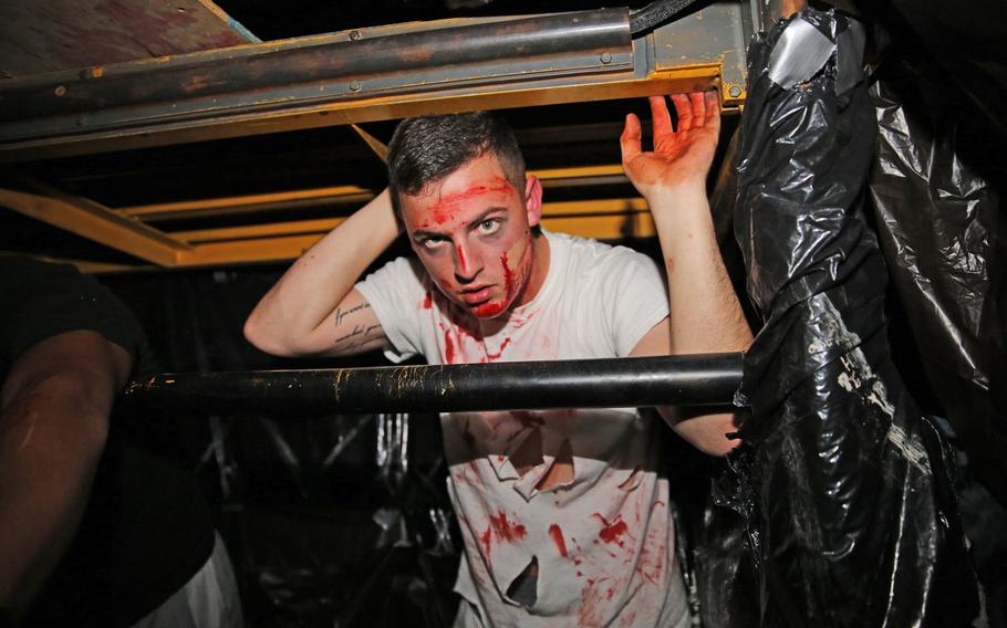 Pfc. Jonathan W. Pope Jr. acts as a caged zombie inside a haunted house Oct. 25 aboard Cherry Point, N.C. While driving, be sure to watch for zombies who have escaped their cage and are roaming the air station in search of candy today.